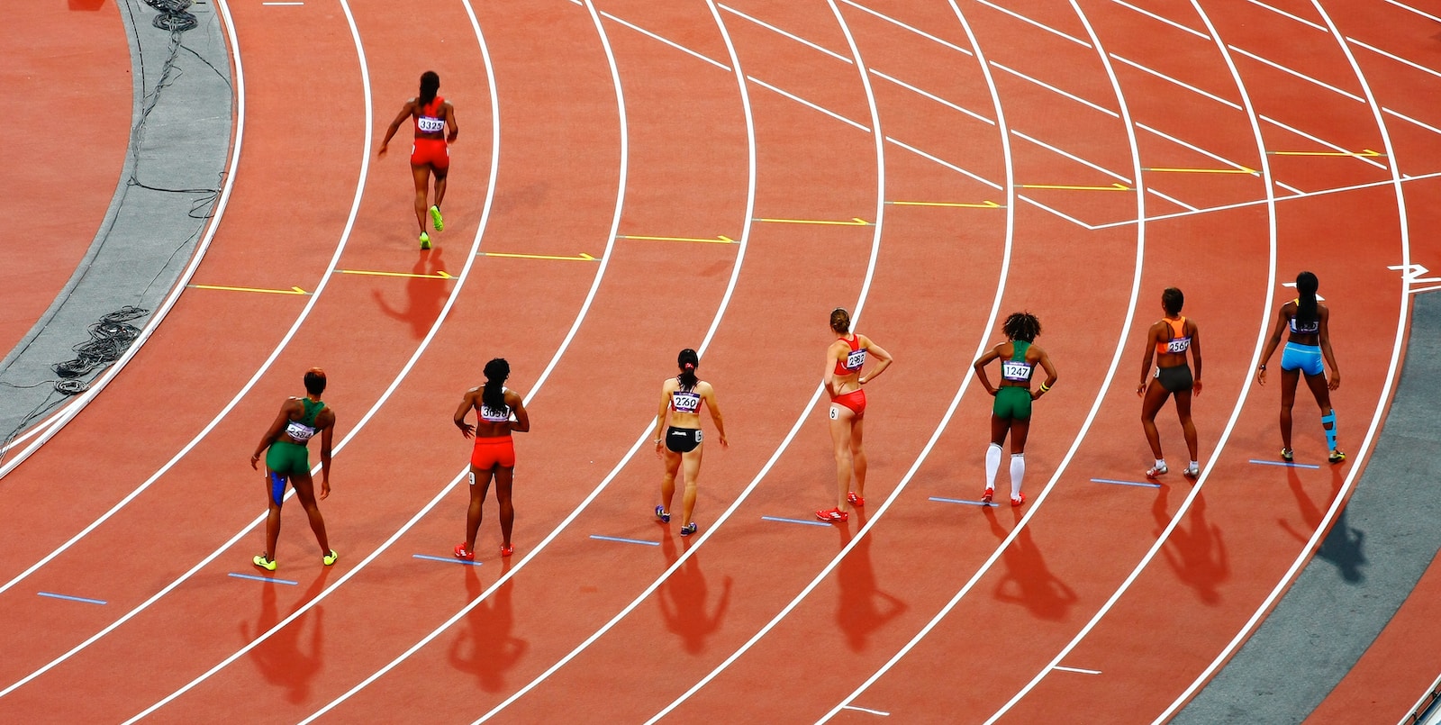 women running on race track during daytime